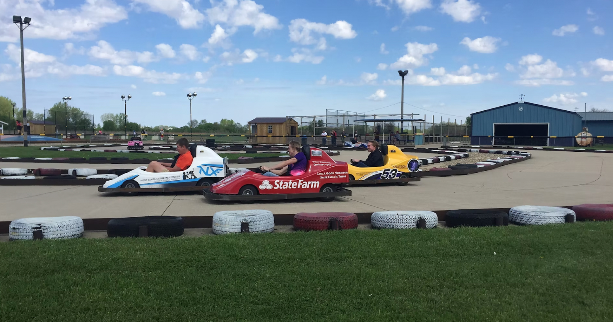 Three go-karts riding around a track.