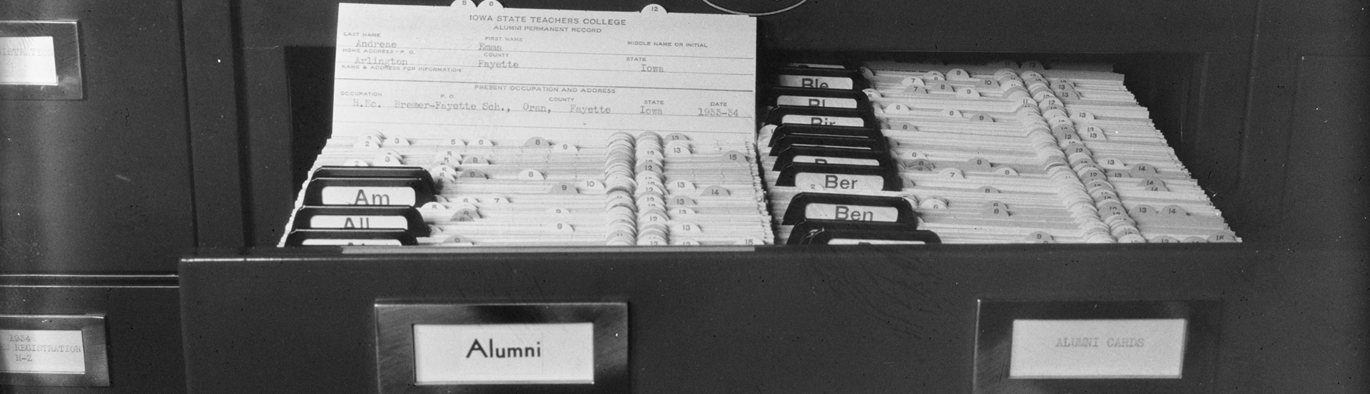 A file cabinet labeled "Alumni" with the record of an Iowa State Teachers College alum