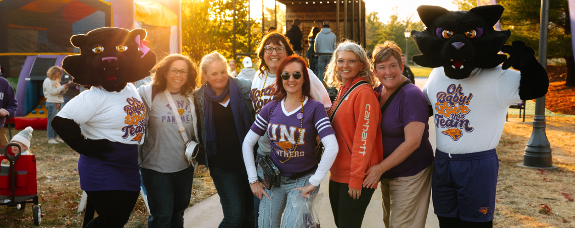TC and TK pose with alumni at Homecoming