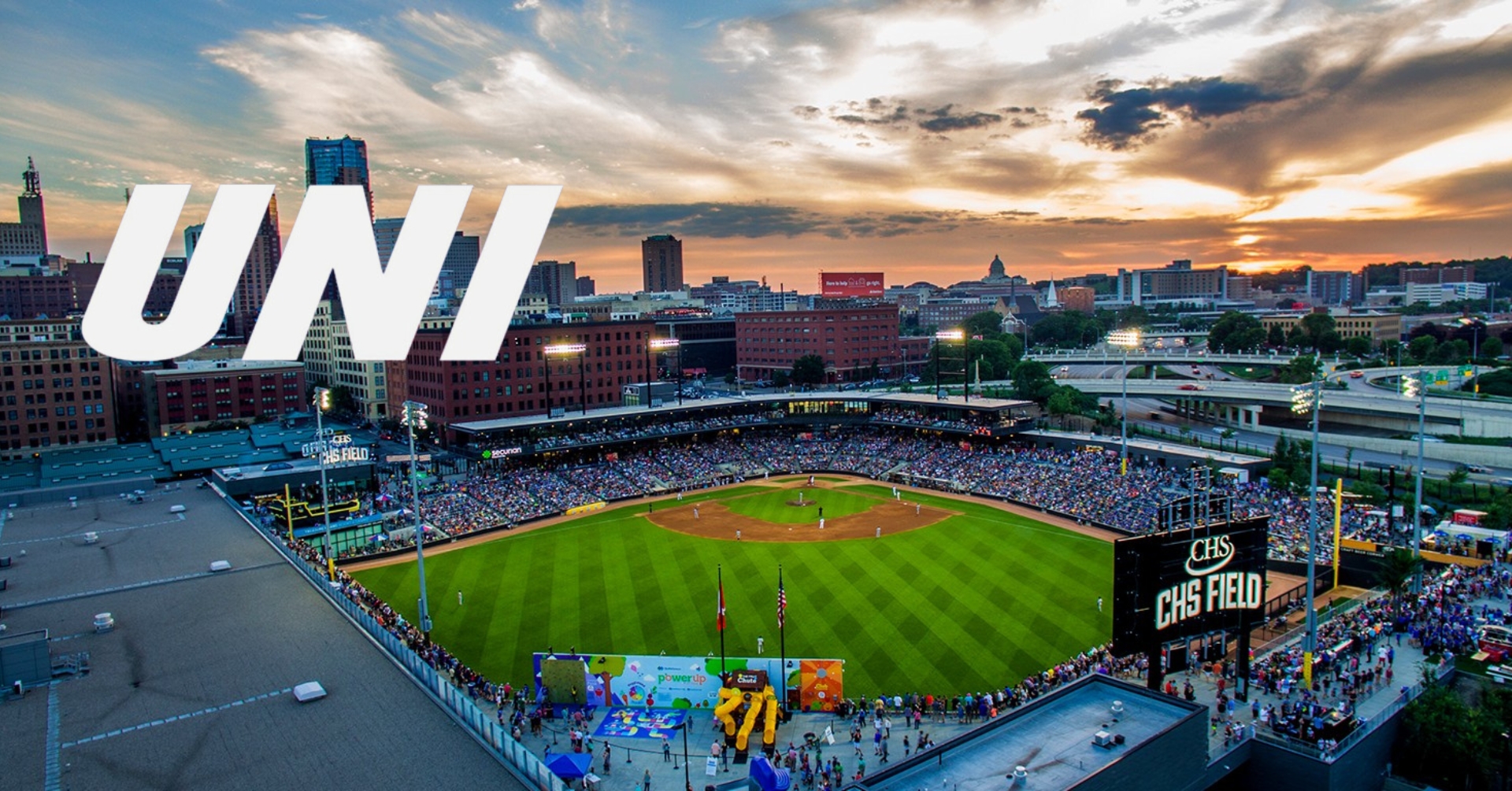 Graphic with UNI letters and photo of CHS field at sunset