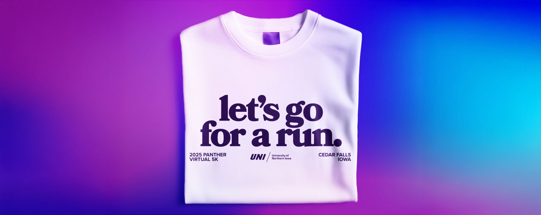 T-shirt on blurry purple and blue background with this text: Let's go for a run. 2025 Panther Virtual 5K. Cedar Falls, Iowa. UNI logo.