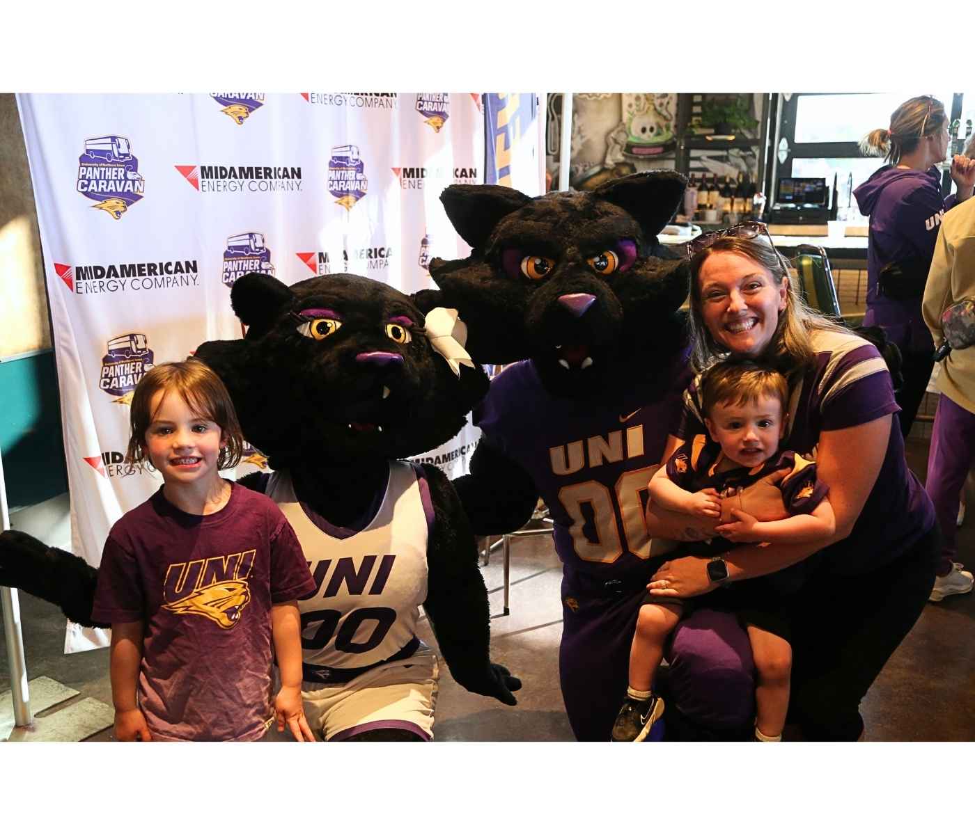 Family posing for photograph at Panther Caravan 2024