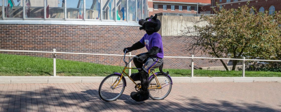 TC riding a bike on University of Northern Iowa Campus