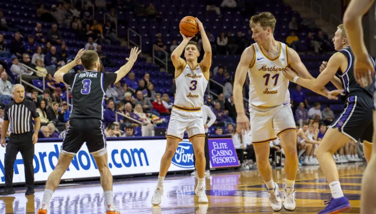 UNI basketball player shooting a hoop.