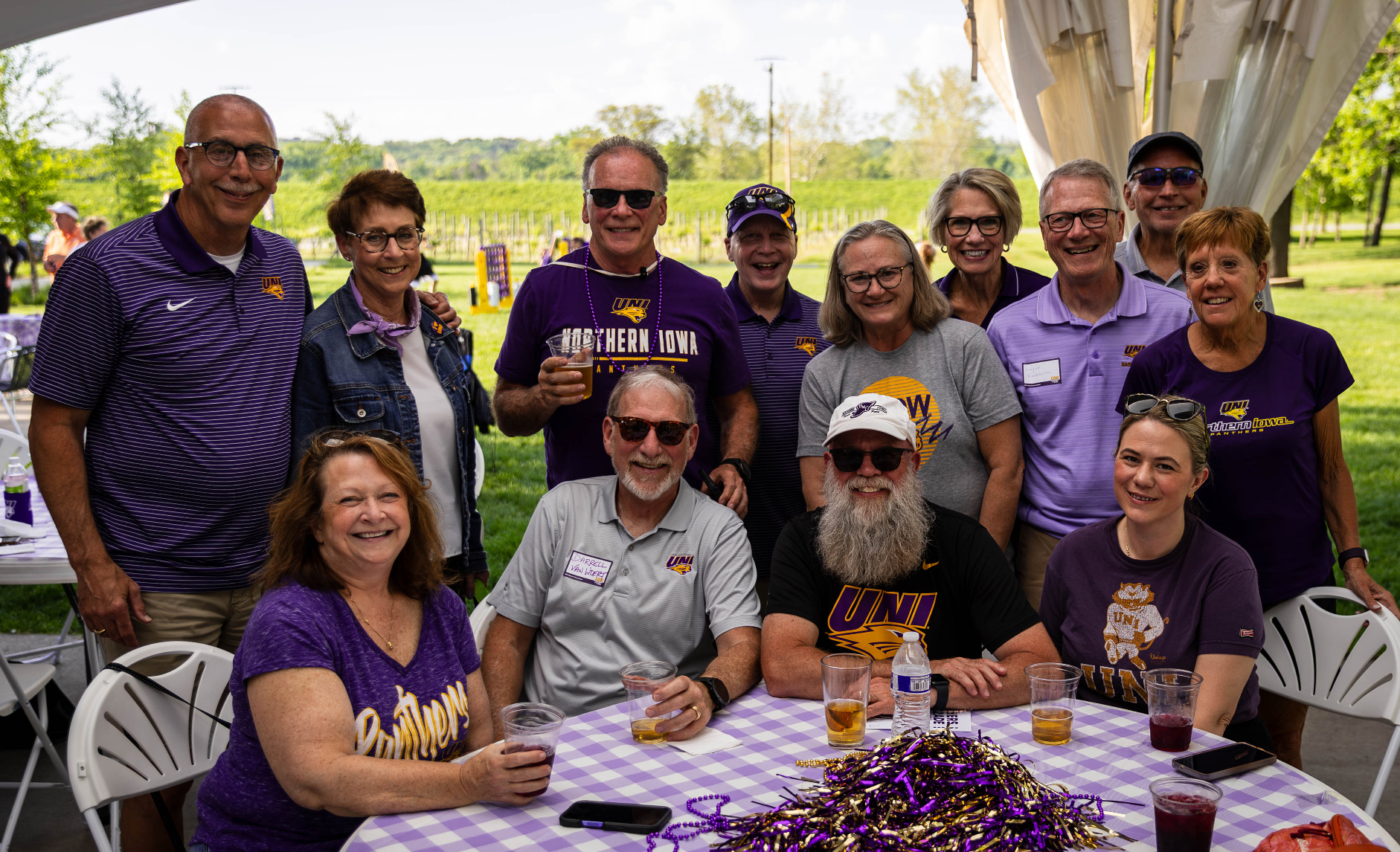 Group of UNI alumni smiling at the camera.