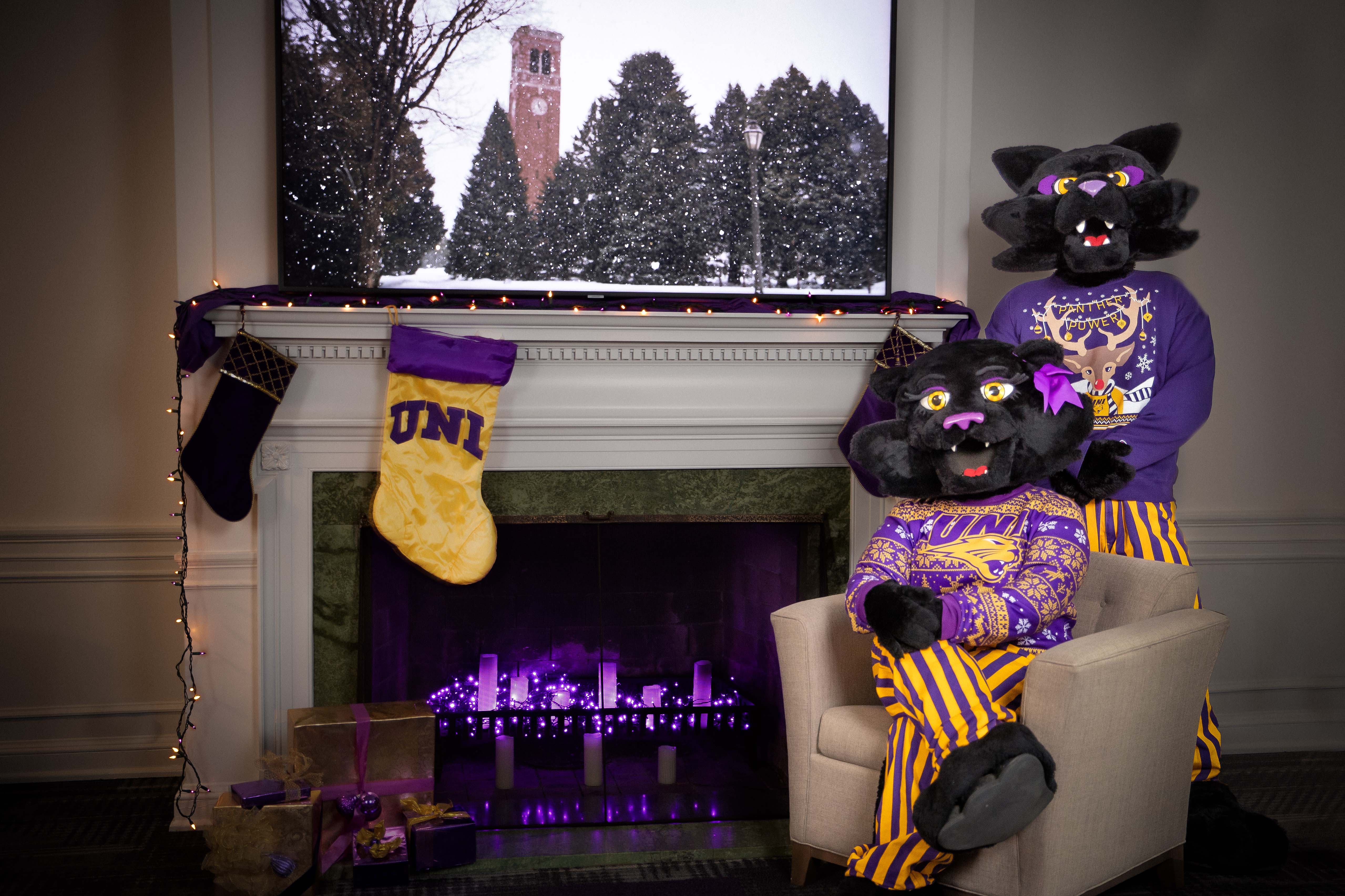 TC and TK around a fireplace with stockings.