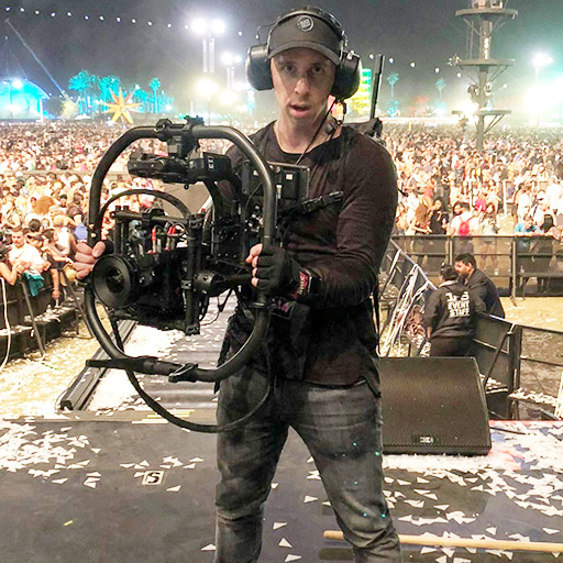Ben Hagarty holding camera equipment at a concert