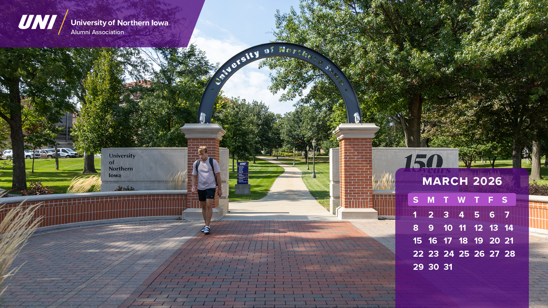 Student walking through UNI arch with calendar graphics.