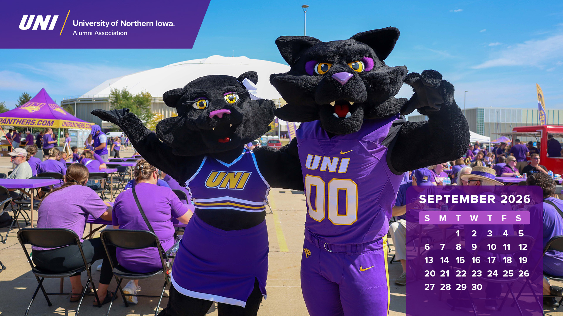 TC and TK posting in front of the UNI Dome with calendar graphics.