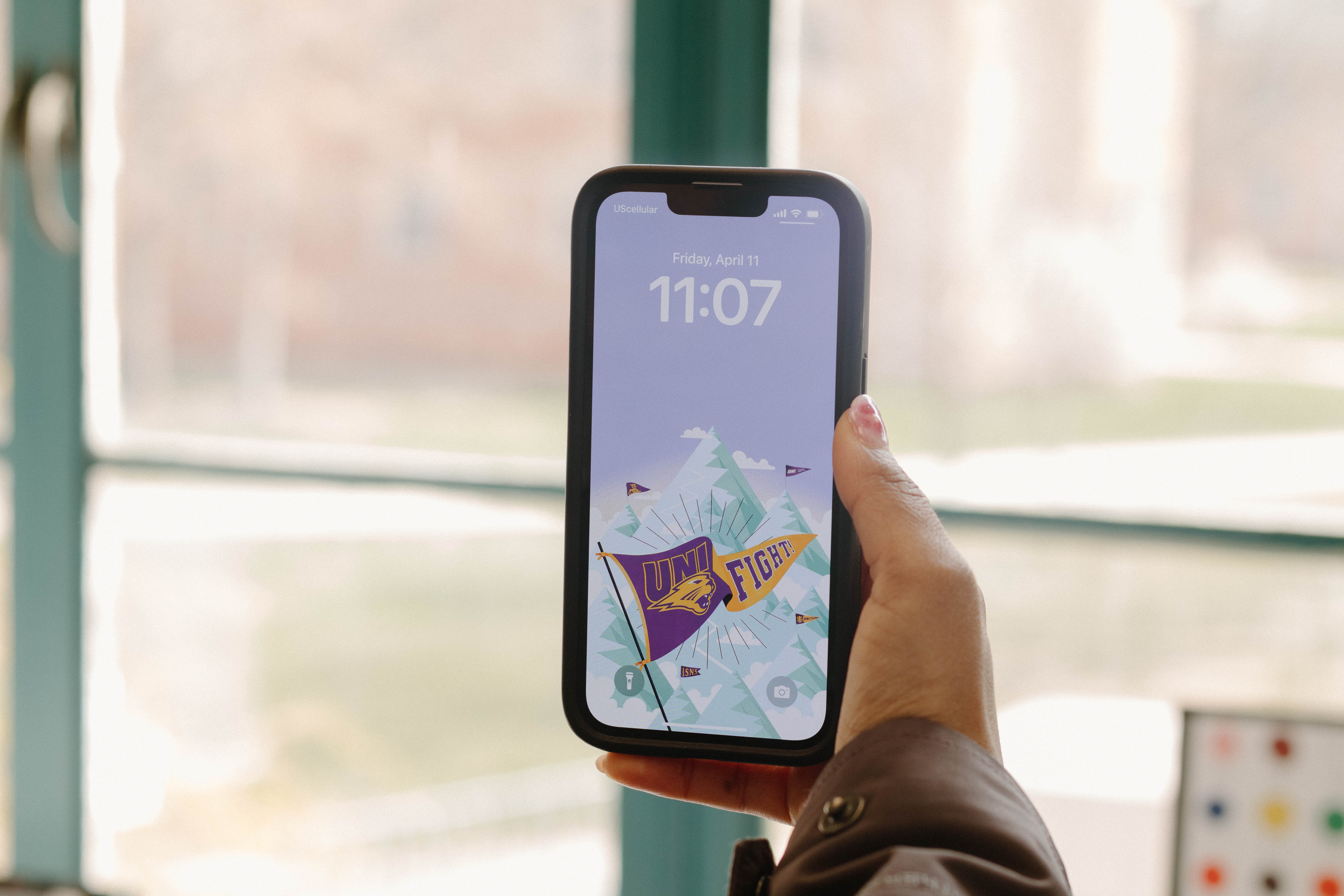 iPhone with UNI wallpaper