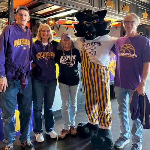 TC with a group of Panther basketball fans at the 2024 Arch Madness Tournament