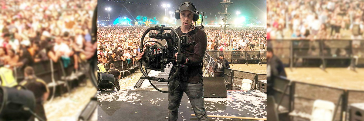 Ben Hagarty holding camera equipment at a concert