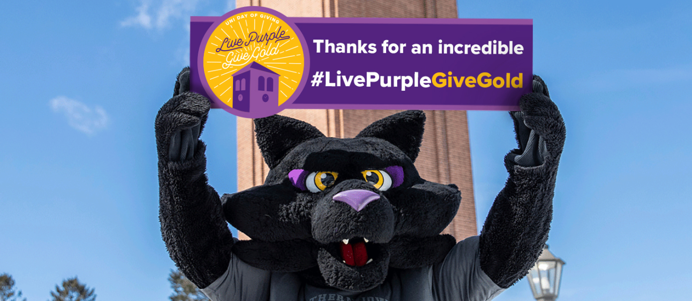 UNI Day of Giving #LivePurpleGiveGold graphic-TC holding a purple and gold sign that says-thanks for an incredible #LivePurpleGiveGold