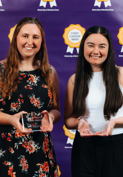 Madison Duong & Mallory Hendricks holding their awards.