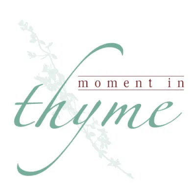 Logo with cursive text reading "Moment in Thyme" and a thyme plant illustration