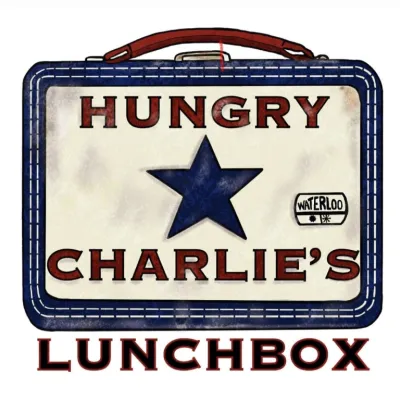 Vintage lunchbox with blue star and text “Hungry Charlie’s Lunchbox"