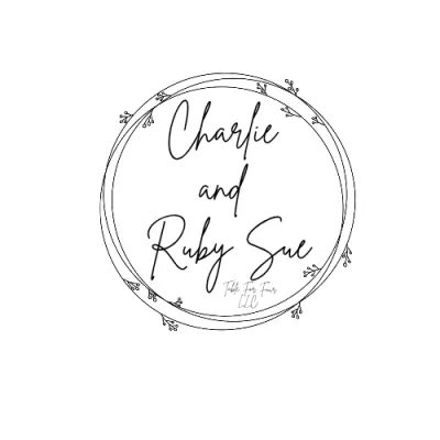 Minimalist black circular frame with small leaf accents; inside, handwritten-style text reads “Charlie and Ruby Sue” with smaller text “Table Two Farm LLC.”